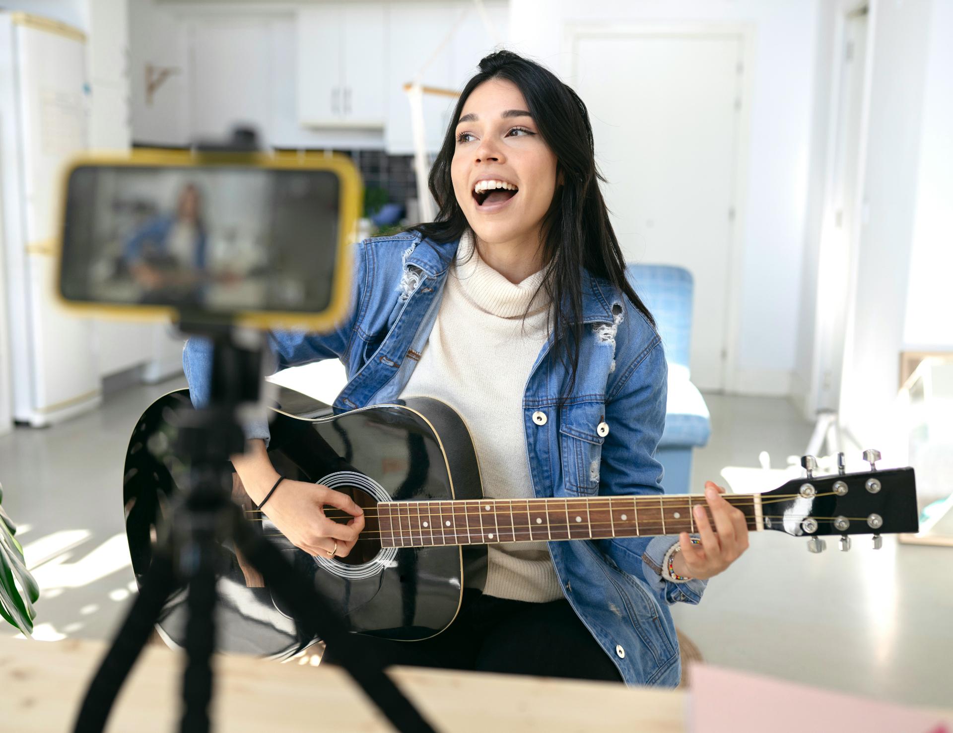 A small-business owner filming a product on a phone in their shop